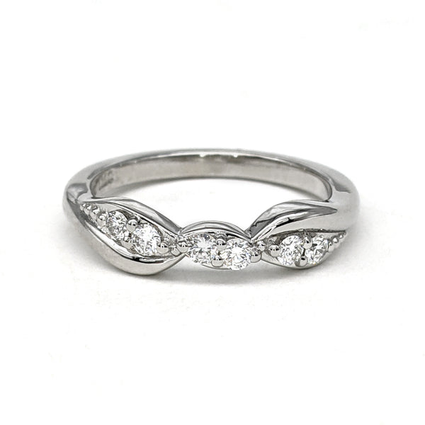 White gold and diamond bypass style wedding ring sitting on a white background.